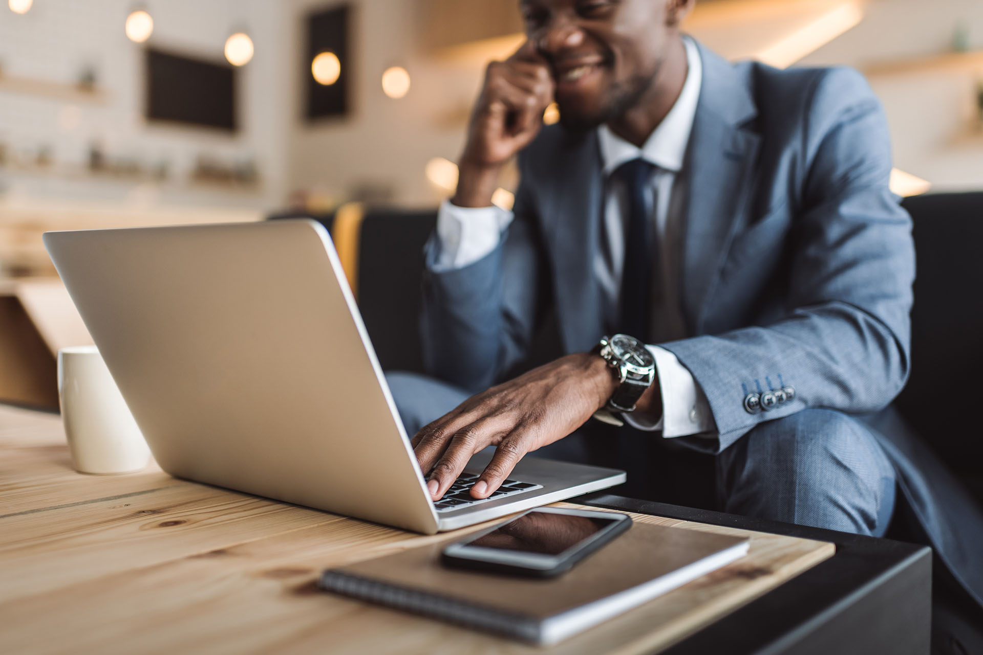 selective focus of handsome african american businessman using l