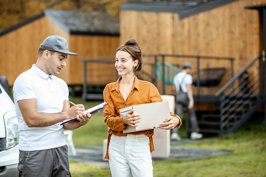 Couriers delivering goods to a woman home