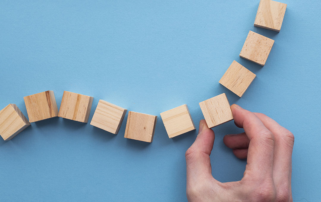 Hand choosing a wooden block from a set. Business choice concept